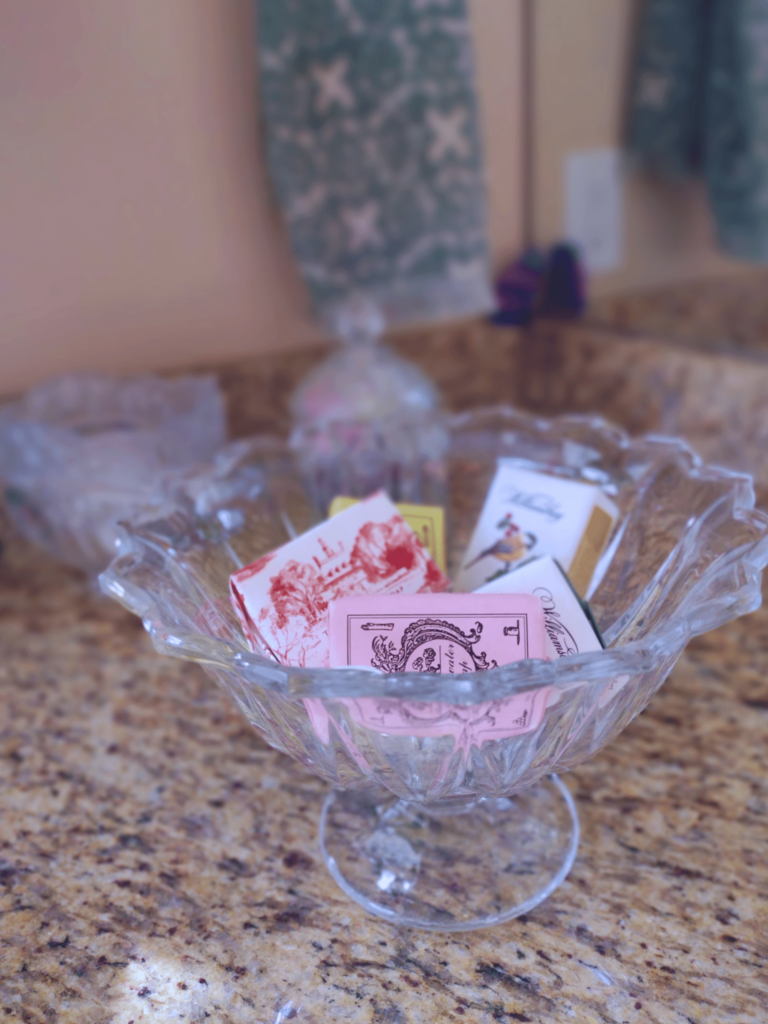 soaps displayed in an antique crystal dish