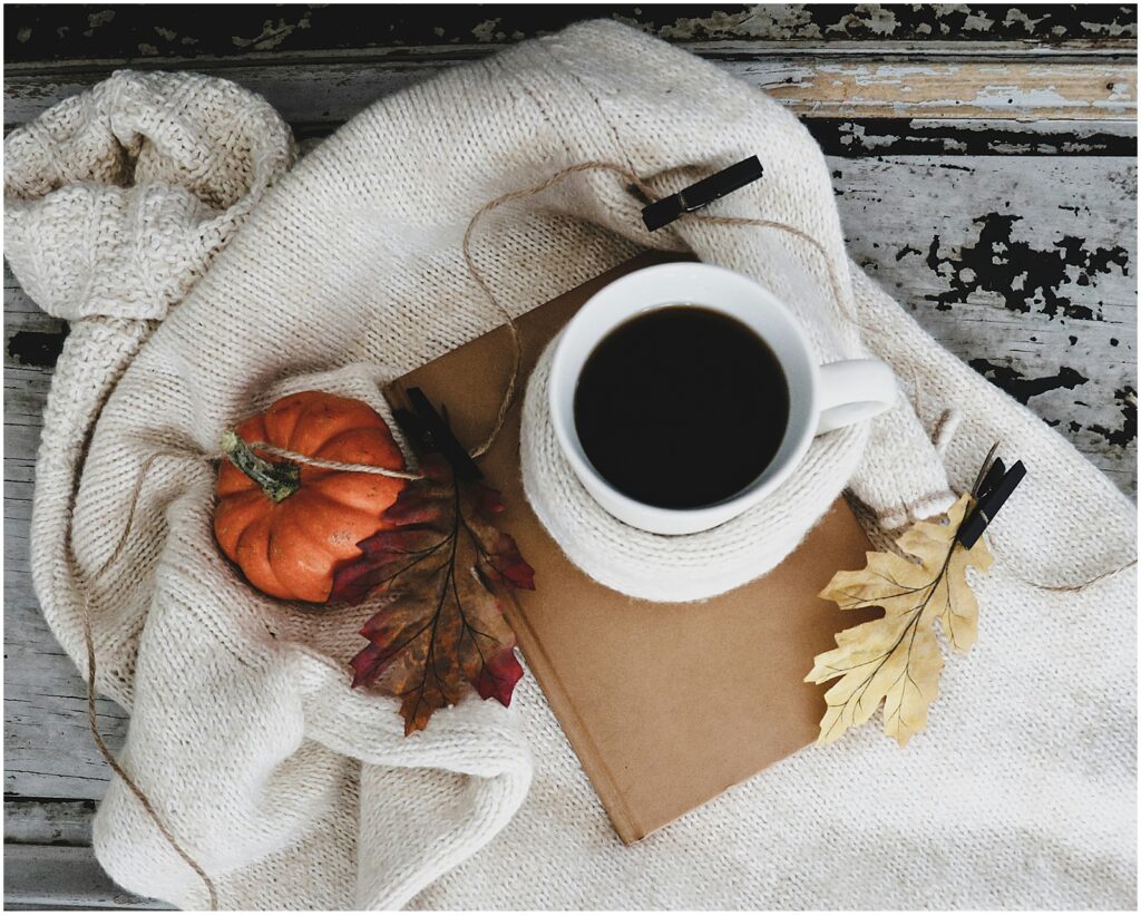 A cup of coffee and a cozy sweater for fall